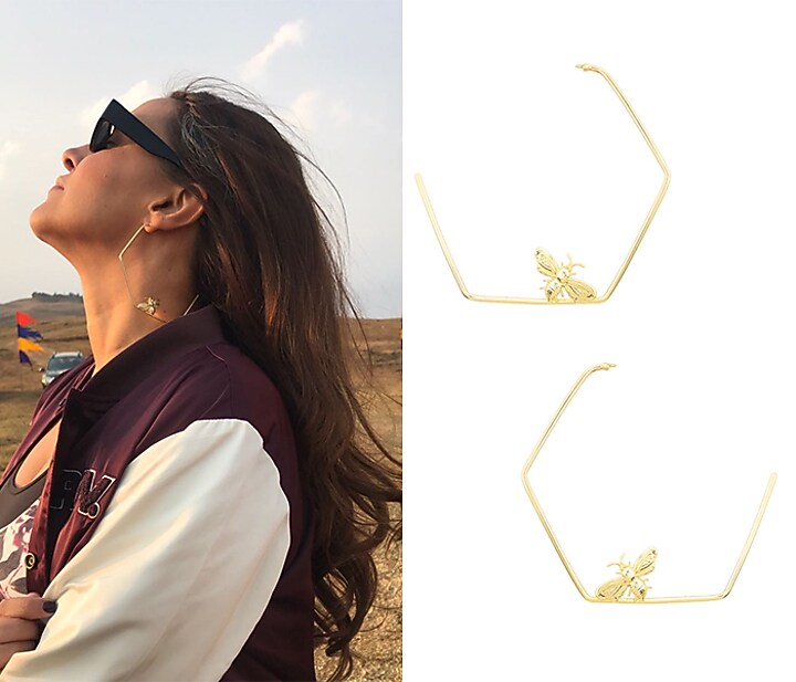Gold finish killer bee hoops earrings available only at Pernia's Pop Up Shop.