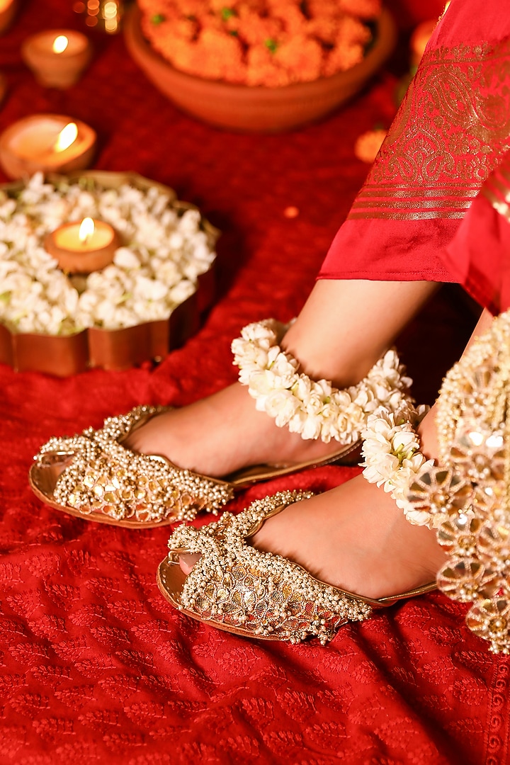 Gold Leatherette Floral Motif Embroidered Juttis by 5 Elements at Pernia's Pop Up Shop