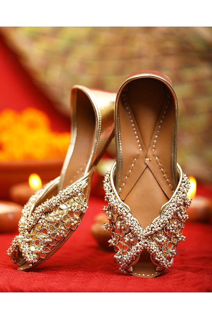 Gold Leatherette Floral Motif Embroidered Juttis by 5 Elements at Pernia's Pop Up Shop