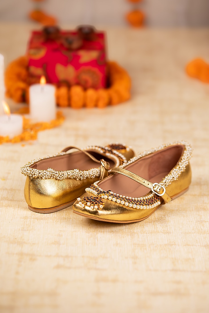 Gold Leatherette Pearl & Crystal Embellished Juttis by 5 Elements at Pernia's Pop Up Shop