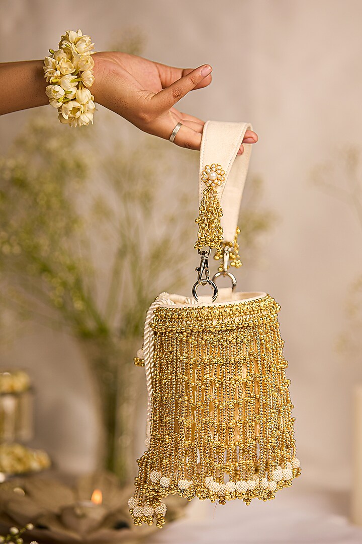 Golden Faux Leather Tassels Embellished Cylindrical Handbag by 5 Elements at Pernia's Pop Up Shop