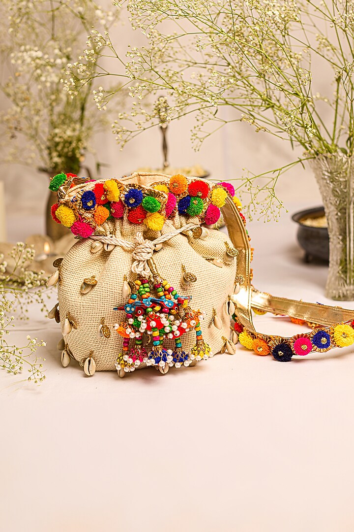 Off-White Jute Pom-Pom Embellished Potli Bag by 5 Elements at Pernia's Pop Up Shop