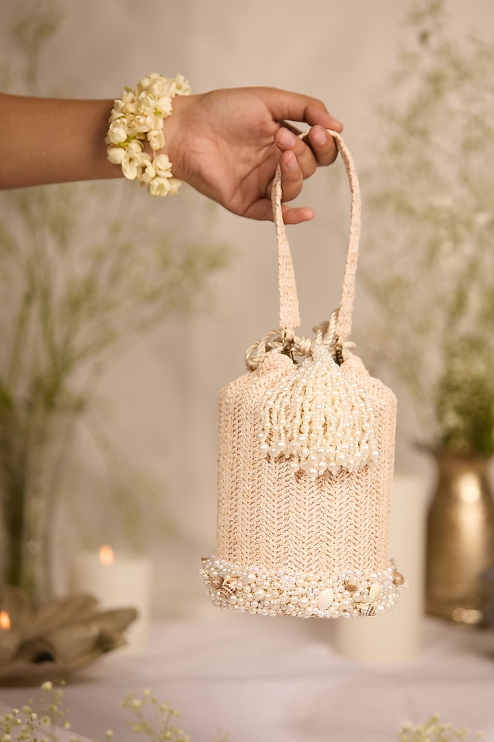 Off-White Jute Seashell Embellished Cylindrical Potli Bag by 5 Elements at Pernia's Pop Up Shop