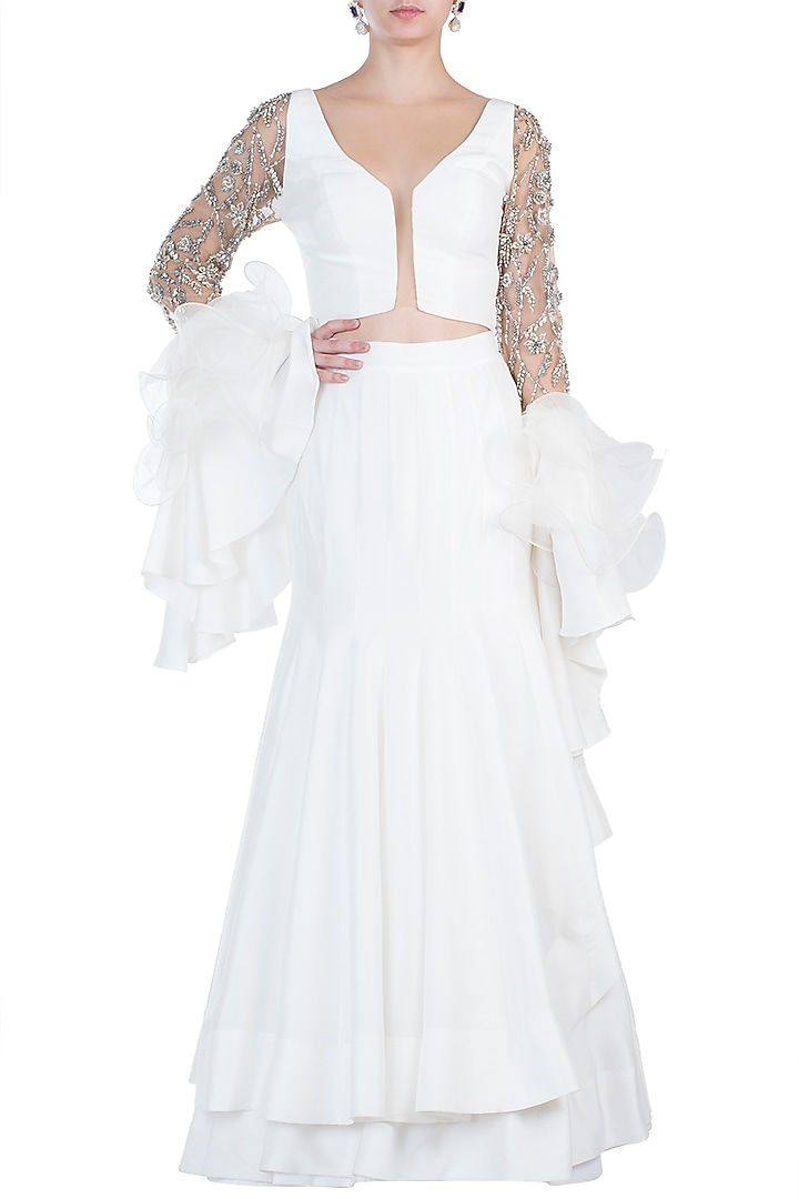 Ivory embroidered ruffle blouse with lehenga skirt available only at Pernia's Pop Up Shop.