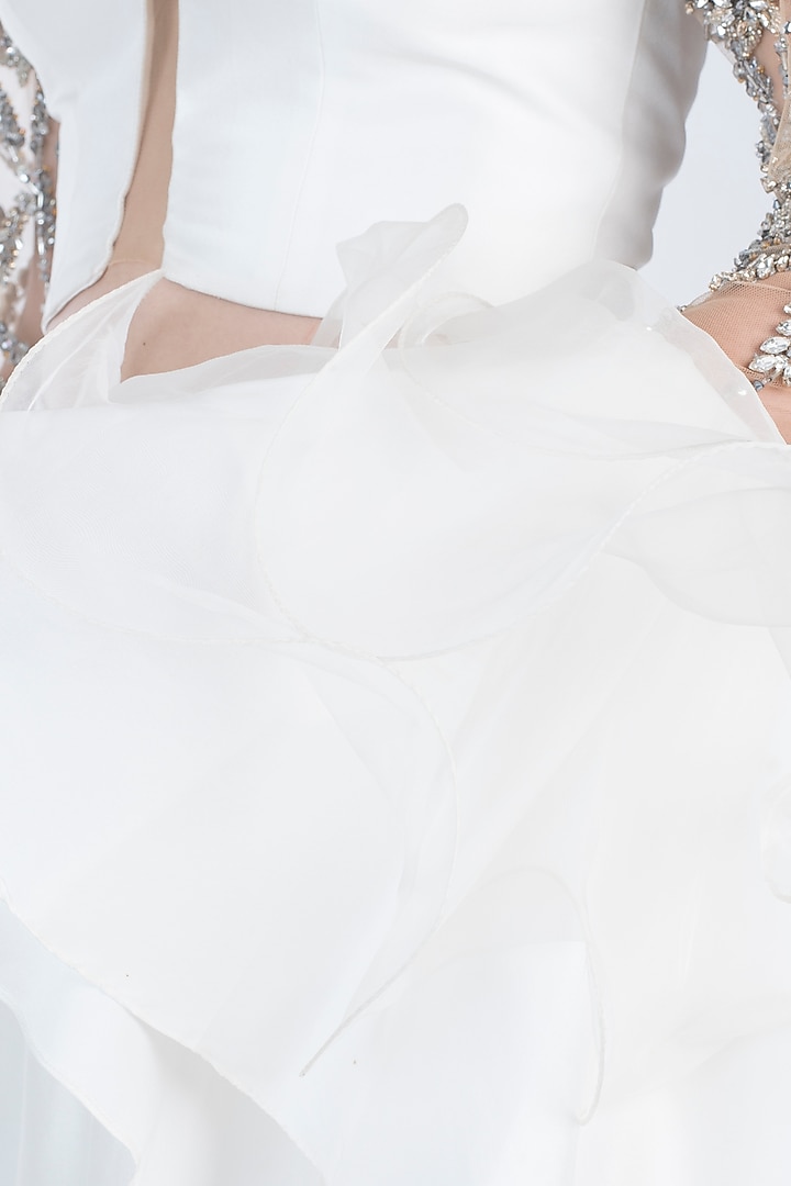 Ivory embroidered ruffle blouse with lehenga skirt available only at Pernia's Pop Up Shop.