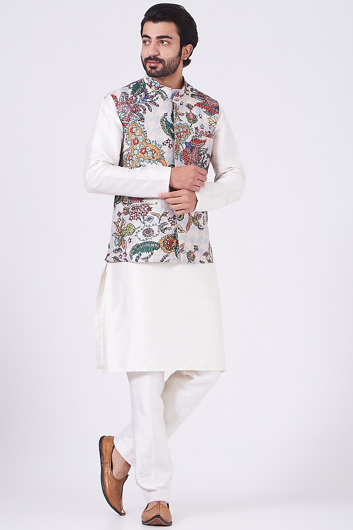 Featuring a white bundi jacket in raw silk base with juna and embellishments. It is paired with a contrasting kurta and pants. 

FIT: True to size. 
COMPOSITION: Raw Silk. 
CARE: Dry clean only. by Aisha Rao Men