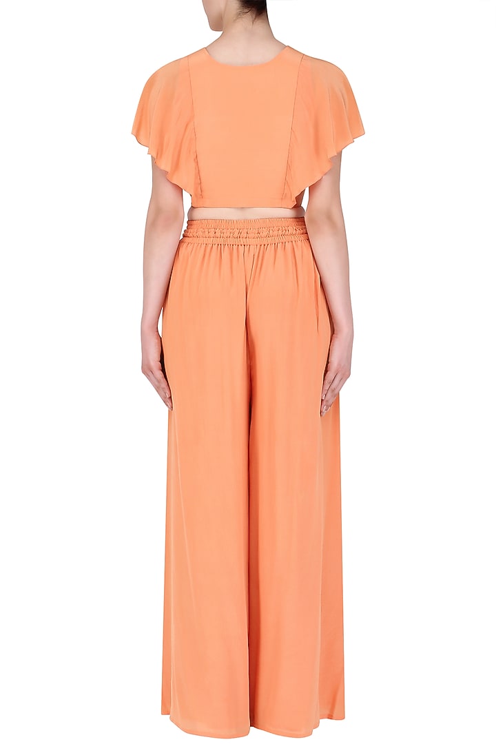Coral peach embroidered top with flared pants available only at Pernia's Pop Up Shop.