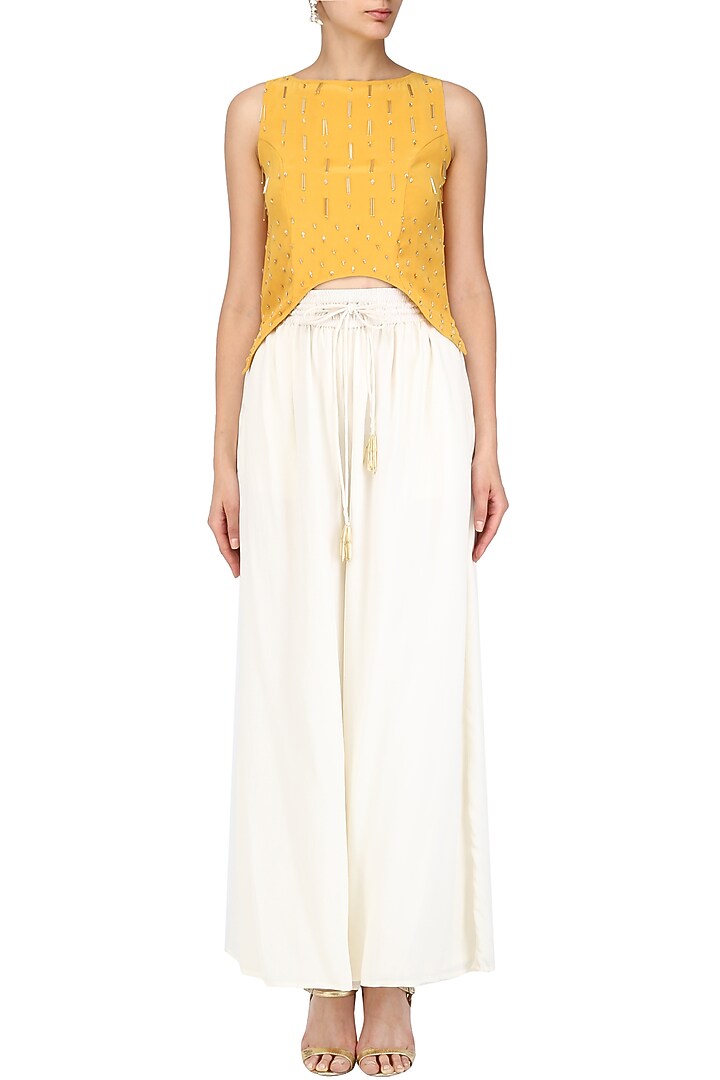 Mariegold yellow asymmetric top with ivory pants set available only at Pernia's Pop Up Shop.