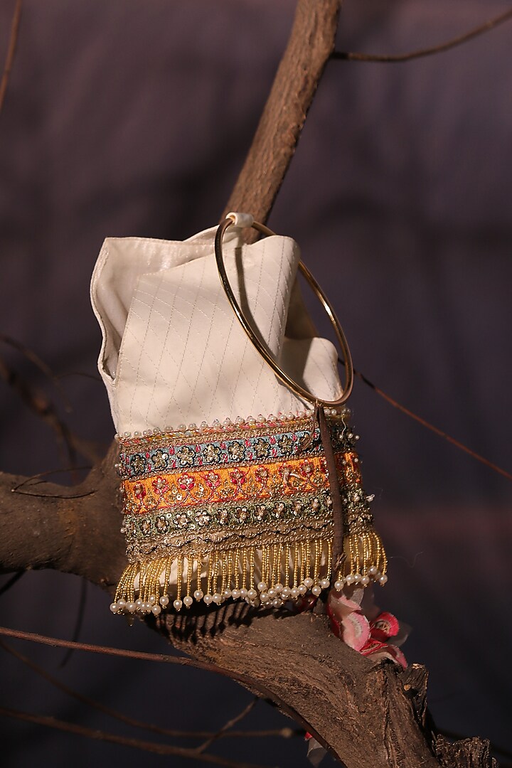 Ivory Satin Tasseled Quilted Potli by Aditi Gupta at Pernia's Pop Up Shop