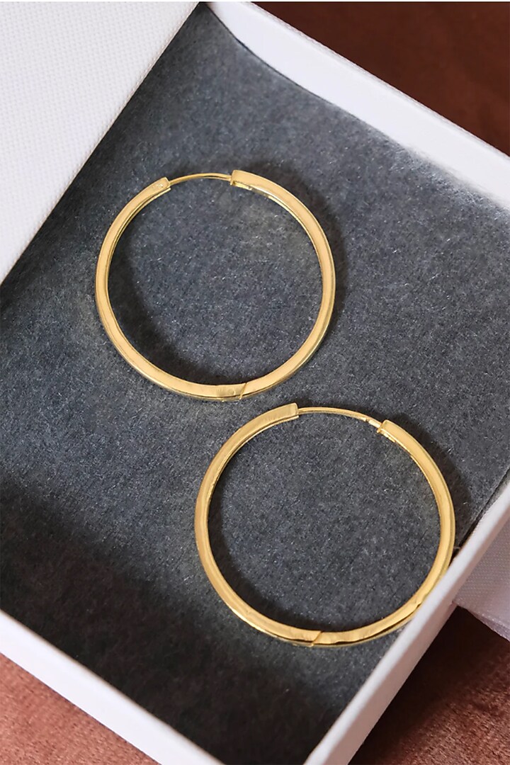 Gold Finish Hoop Earrings In Sterling Silver by Anushka Jain at Pernia's Pop Up Shop