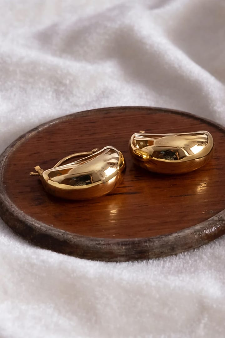 Gold Finish Hoop Earrings In Sterling Silver by Anushka Jain at Pernia's Pop Up Shop