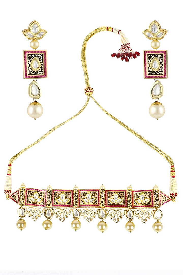 Antique gold finish textured polki and ruby choker with polki flower earrings by Anjali Jain