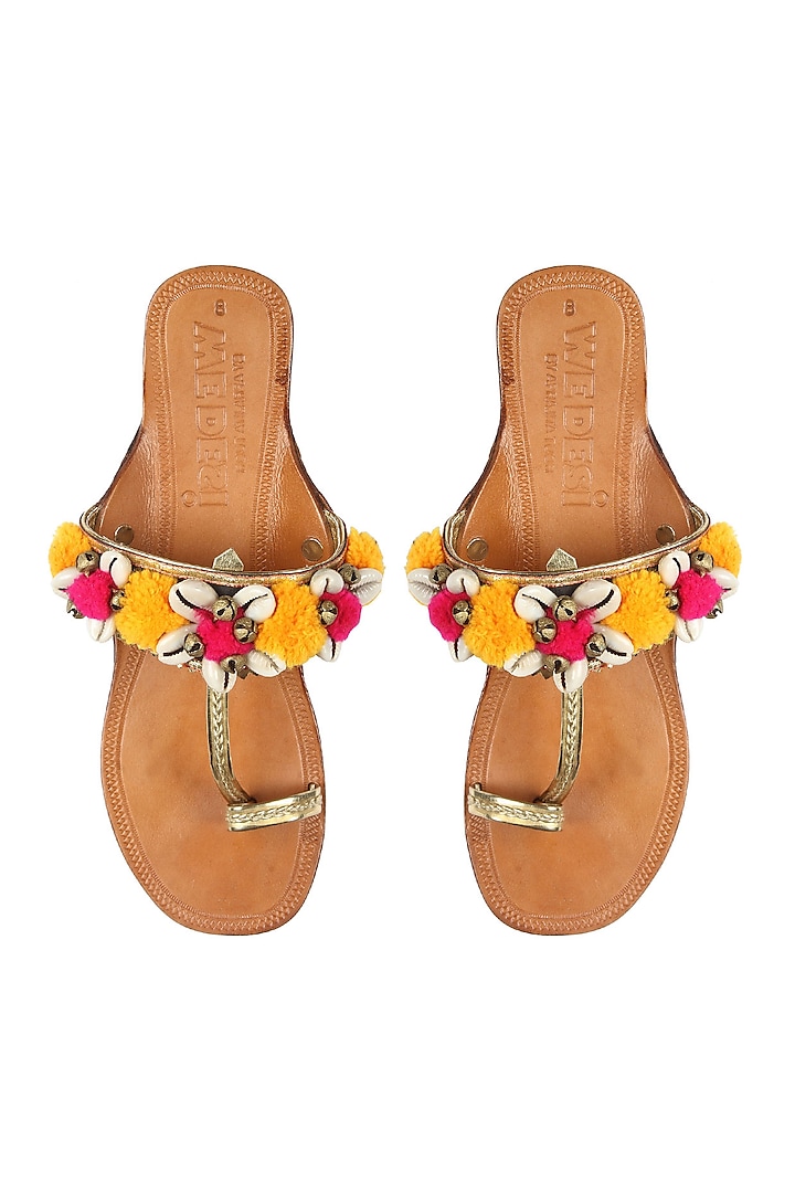 Nude kolhapuri flats with yellow and pink pompoms by Aprajita Toor