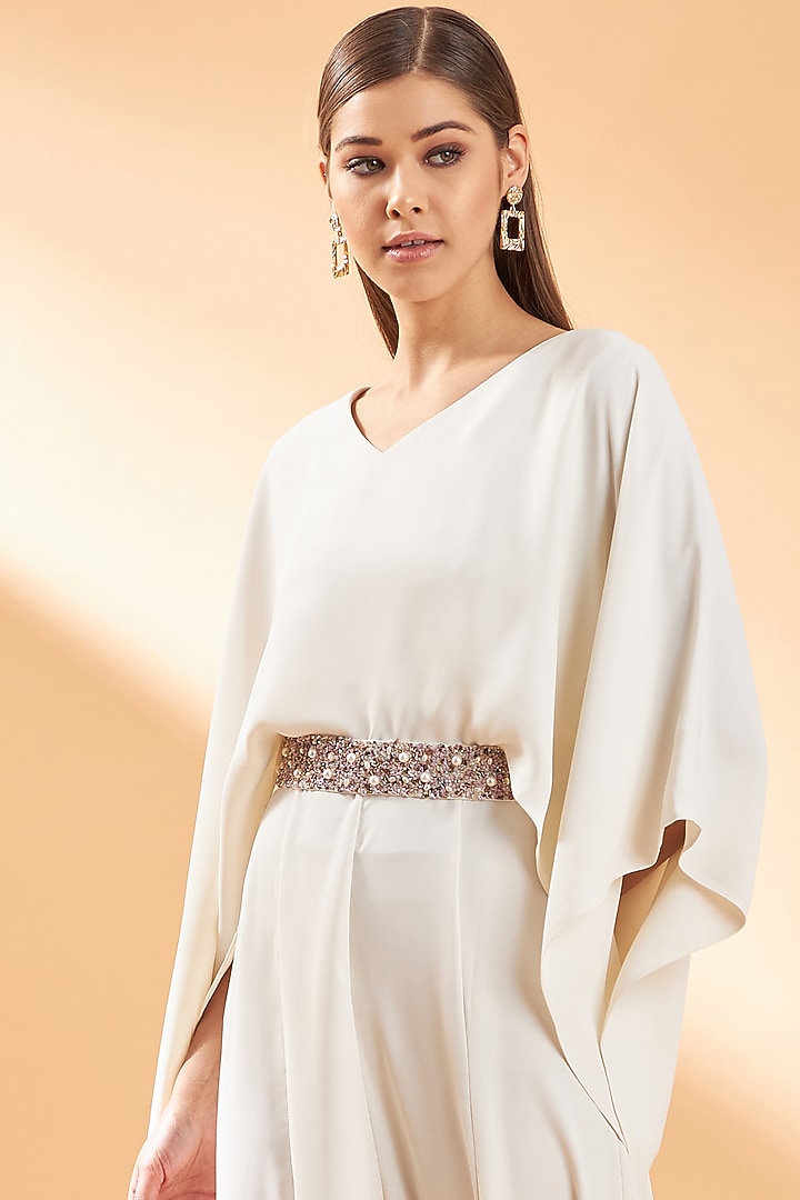 Creme Draped Jumpsuit With Belt by Aakaar at Pernia's Pop Up Shop