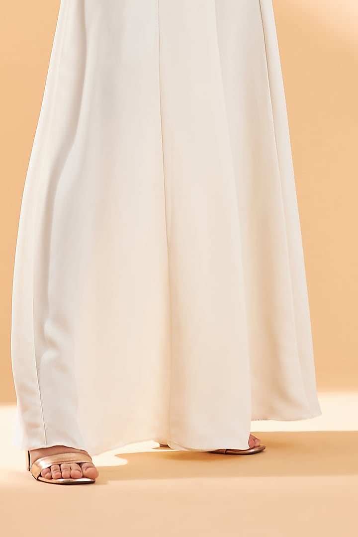 Creme Draped Jumpsuit With Belt by Aakaar at Pernia's Pop Up Shop