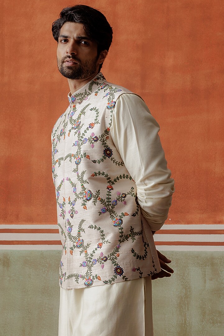 Ivory Raw Silk Kashmiri Embroidered Bundi Jacket by ALLUR at Pernia's Pop Up Shop