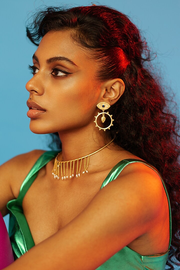 Gold Finish Evil Eye Earrings In Brass by AMAMA at Pernia's Pop Up Shop