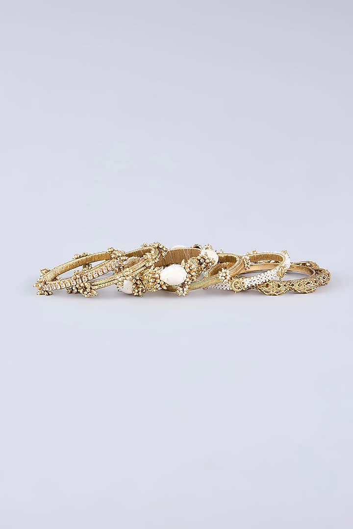 Antique Gold Plated Faux Pearl & Cowrie Shell Bangles (Set Of 6) by AMAMA at Pernia's Pop Up Shop