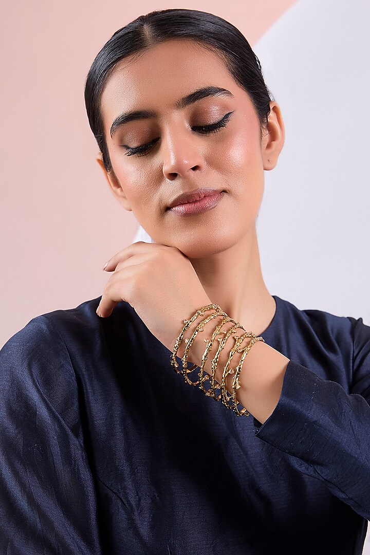 Gold Finish Cubic Zirconia Crest Bangles (Set Of 6) by AMAMA at Pernia's Pop Up Shop