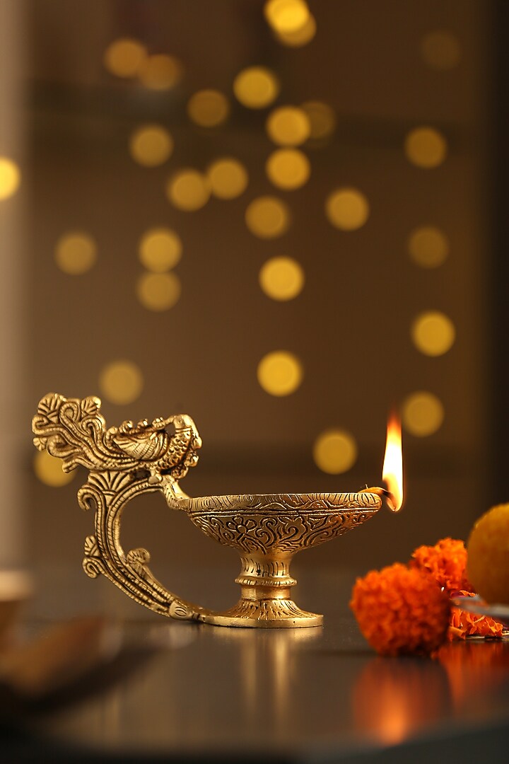 Antique Gold Brass Diya With Bird Handle by Amoliconcepts at Pernia's Pop Up Shop