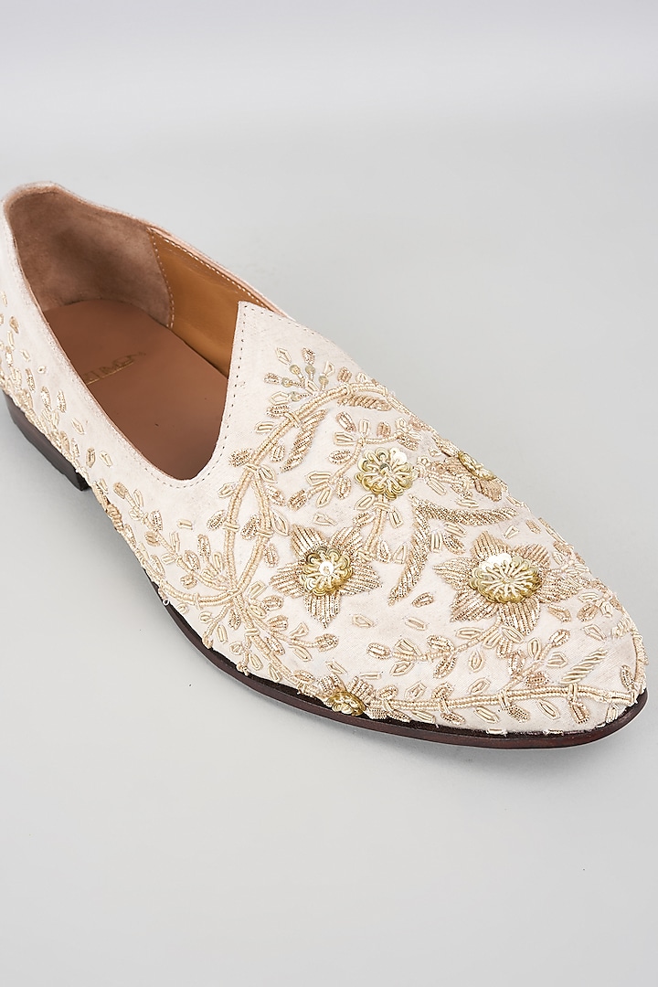 White Raw Silk Hand Embroidered Juttis by ARTIMEN at Pernia's Pop Up Shop