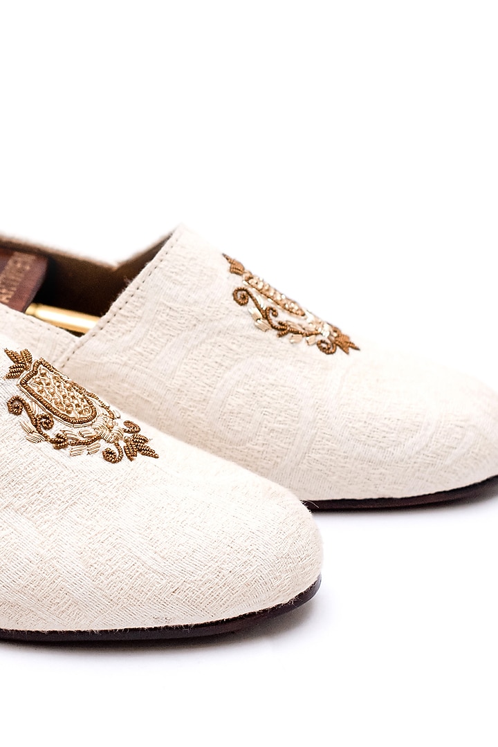 Off-White Stone Washed Fabric Handcrafted Juttis by ARTIMEN at Pernia's Pop Up Shop