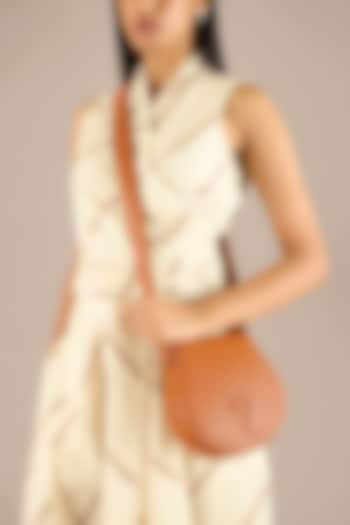 Tan Faux Leather Sling Bag by AMPM Accessories at Pernia's Pop Up Shop