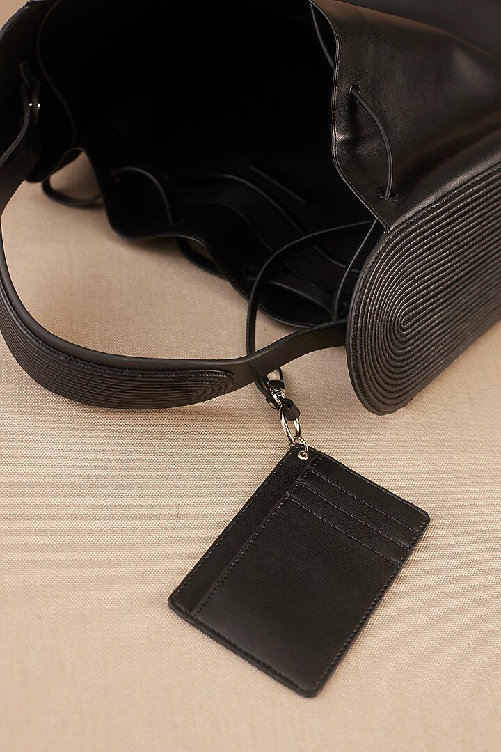 Black Faux Leather Corded Bucket Bag by AMPM Accessories at Pernia's Pop Up Shop