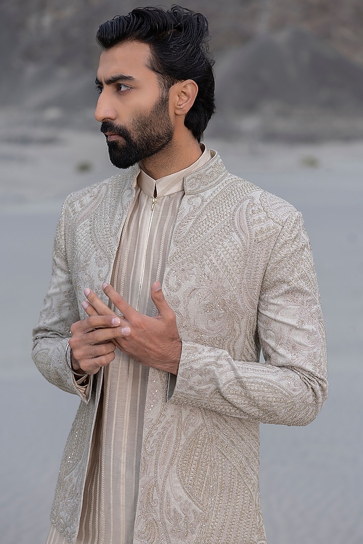 Beige Textured Poly Knit Embroidered Groom Indowestern Set by AMIT ARORA at Pernia's Pop Up Shop