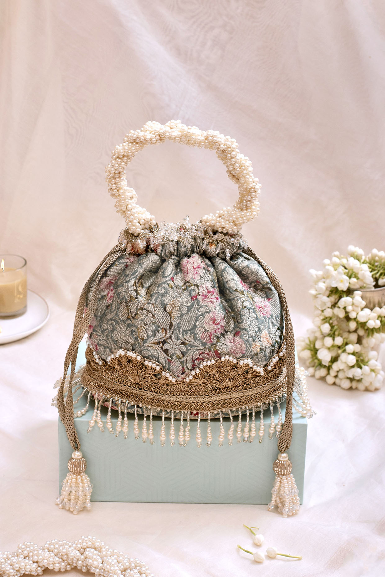 Grey Blue Organza Brocade Printed Potli by AMYRA