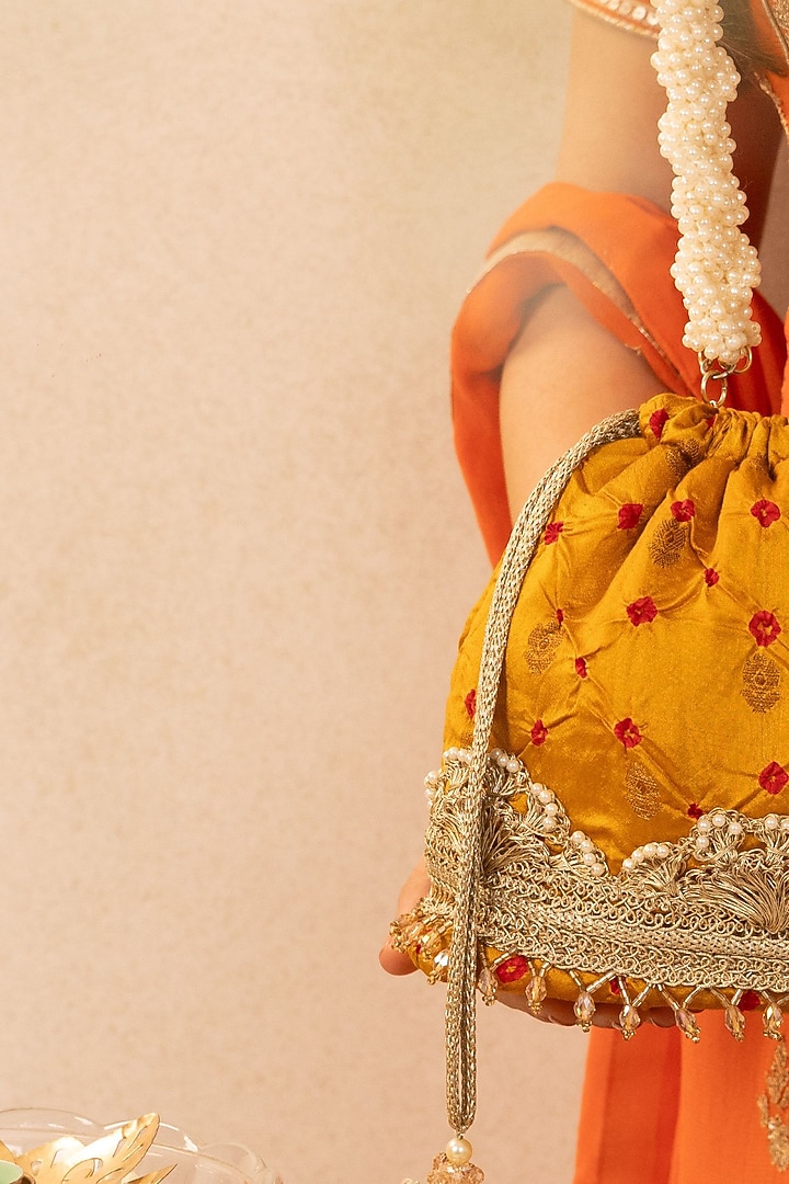 Mustard Bandhani Silk Tie-Dye Bucket Bag by AMYRA at Pernia's Pop Up Shop