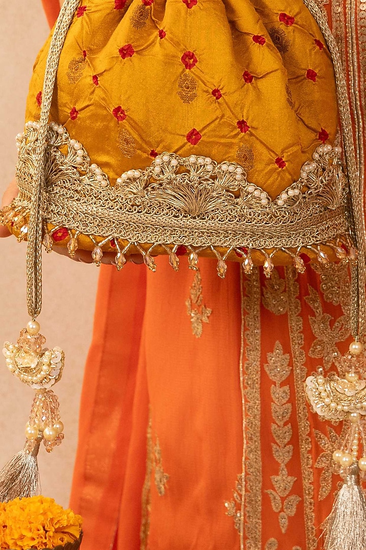 Mustard Bandhani Silk Tie-Dye Bucket Bag by AMYRA at Pernia's Pop Up Shop