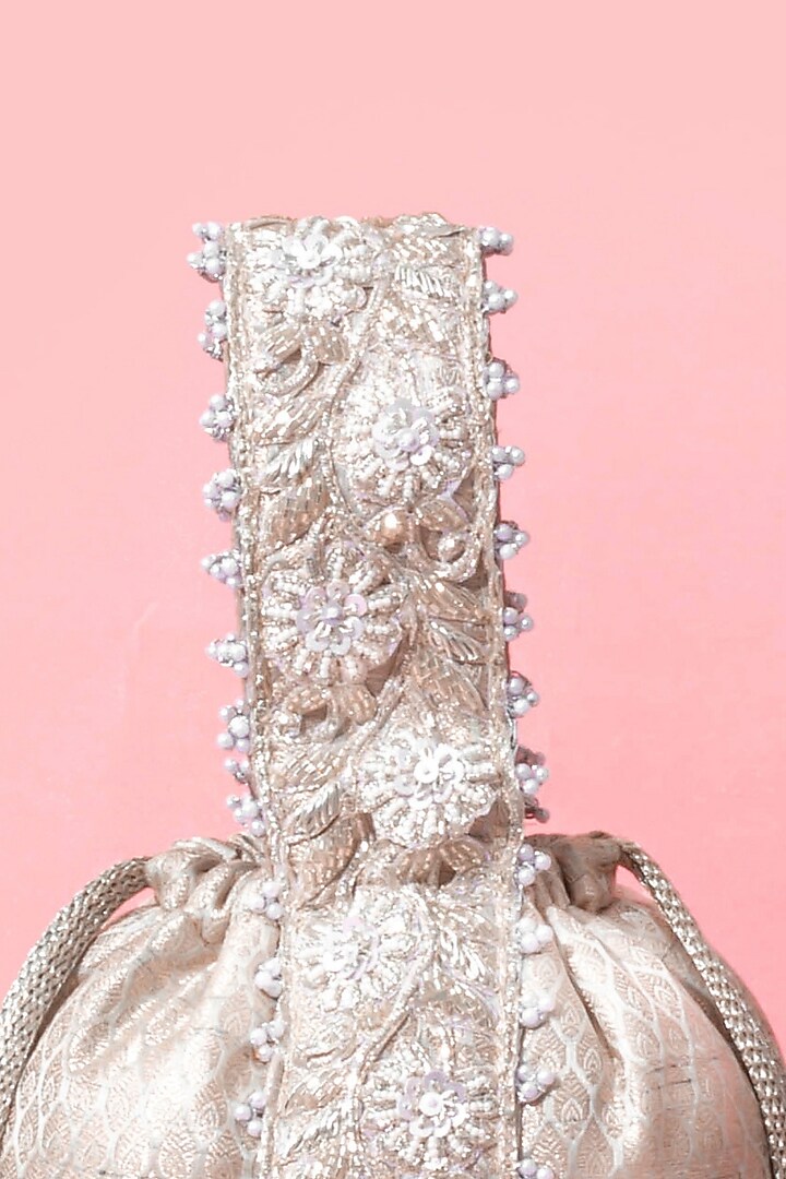Silver Banarasi Zari Thread Tassel & Lace Embroidered Bucket Bag by AMYRA at Pernia's Pop Up Shop