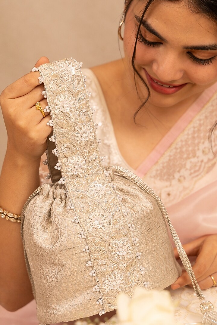 Silver Banarasi Zari Thread Tassel & Lace Embroidered Bucket Bag by AMYRA at Pernia's Pop Up Shop