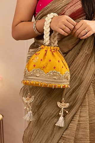 Mustard Bandhani Silk Lace Embellished Bucket Bag by AMYRA