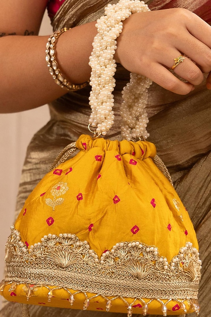 Mustard Bandhani Silk Lace Embellished Bucket Bag by AMYRA at Pernia's Pop Up Shop