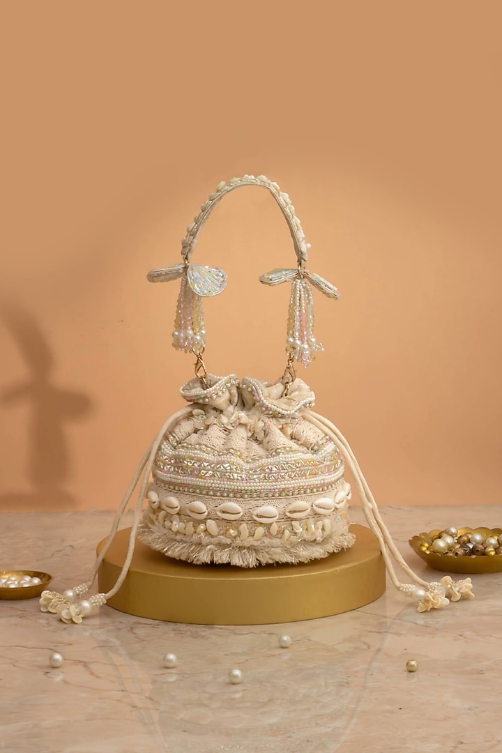 Off-White Poly Silk Cutdana Embellished Potli by AMYRA at Pernia's Pop Up Shop