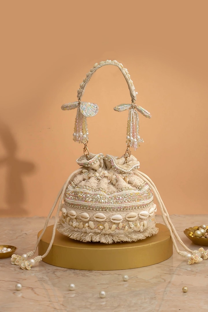 Off-White Poly Silk Cutdana Embellished Potli by AMYRA at Pernia's Pop Up Shop