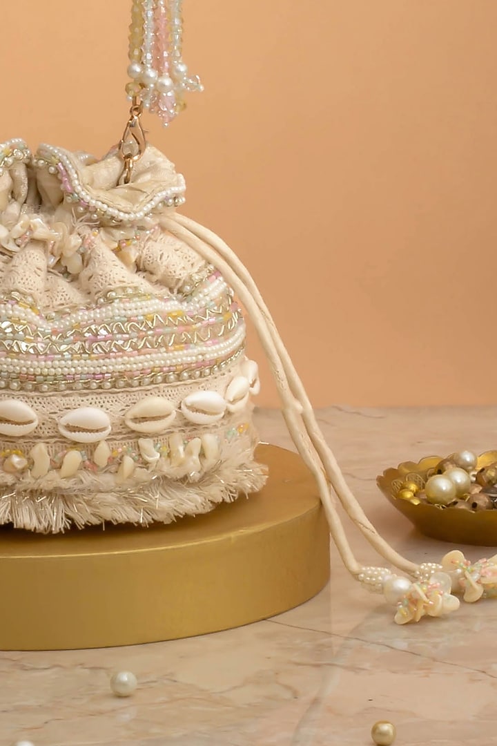 Off-White Poly Silk Cutdana Embellished Potli by AMYRA at Pernia's Pop Up Shop