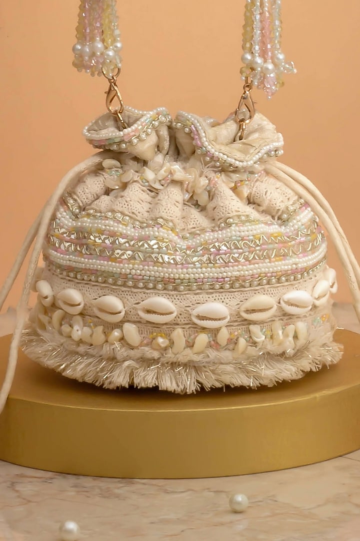 Off-White Poly Silk Cutdana Embellished Potli by AMYRA at Pernia's Pop Up Shop