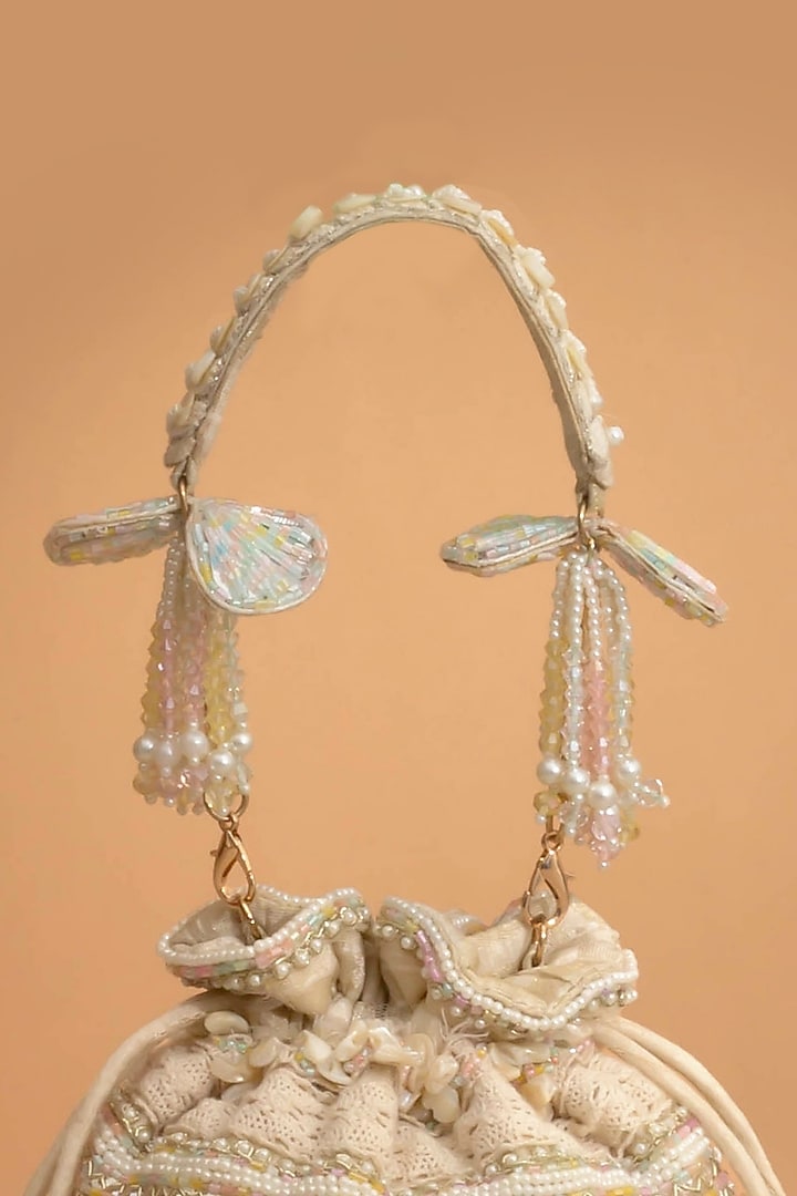 Off-White Poly Silk Cutdana Embellished Potli by AMYRA at Pernia's Pop Up Shop