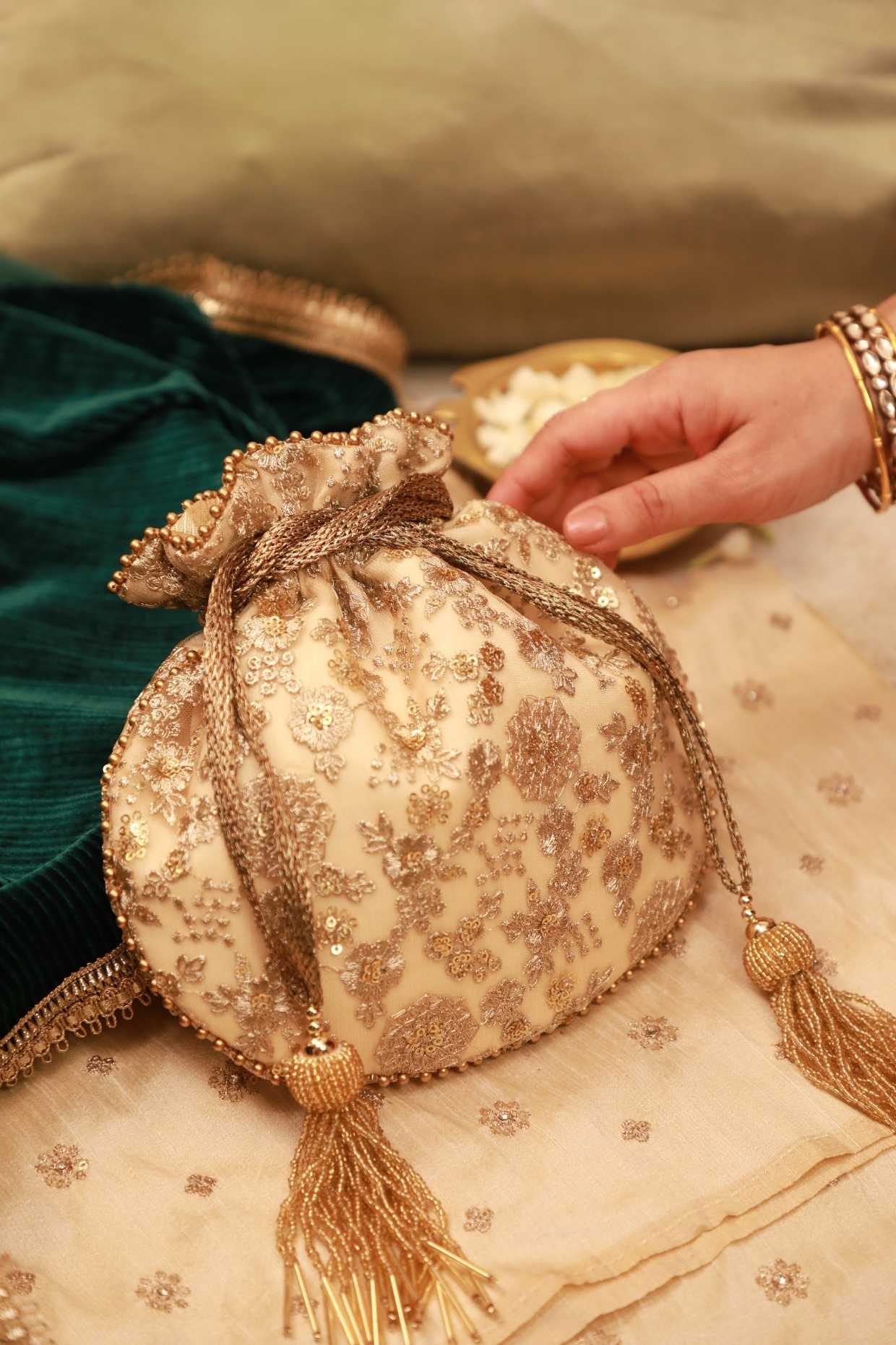 Gold Net Sequins Embroidered Potli by AMYRA at Pernia's Pop Up Shop