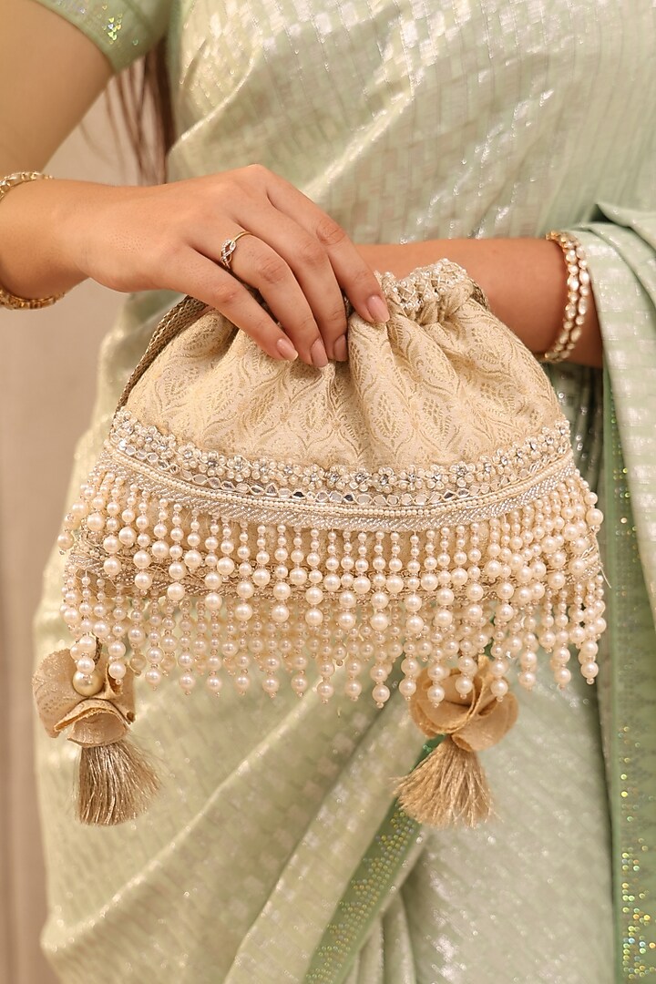 Ivory Tussar Brocade Pearl Tassels Embroidered Potli Bag by AMYRA at Pernia's Pop Up Shop