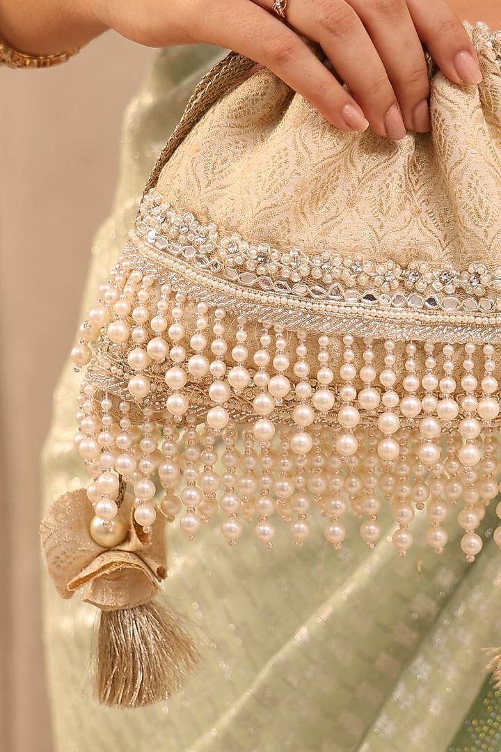Ivory Tussar Brocade Pearl Tassels Embroidered Potli Bag by AMYRA at Pernia's Pop Up Shop