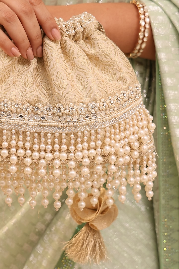 Ivory Tussar Brocade Pearl Tassels Embroidered Potli Bag by AMYRA at Pernia's Pop Up Shop