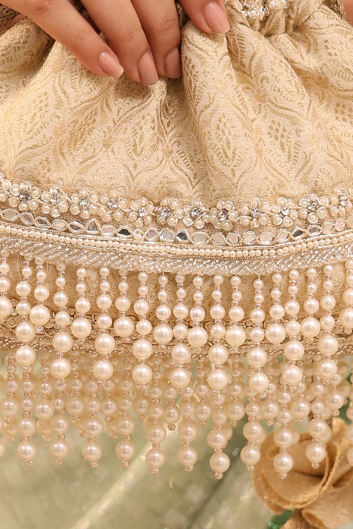 Ivory Tussar Brocade Pearl Tassels Embroidered Potli Bag by AMYRA at Pernia's Pop Up Shop