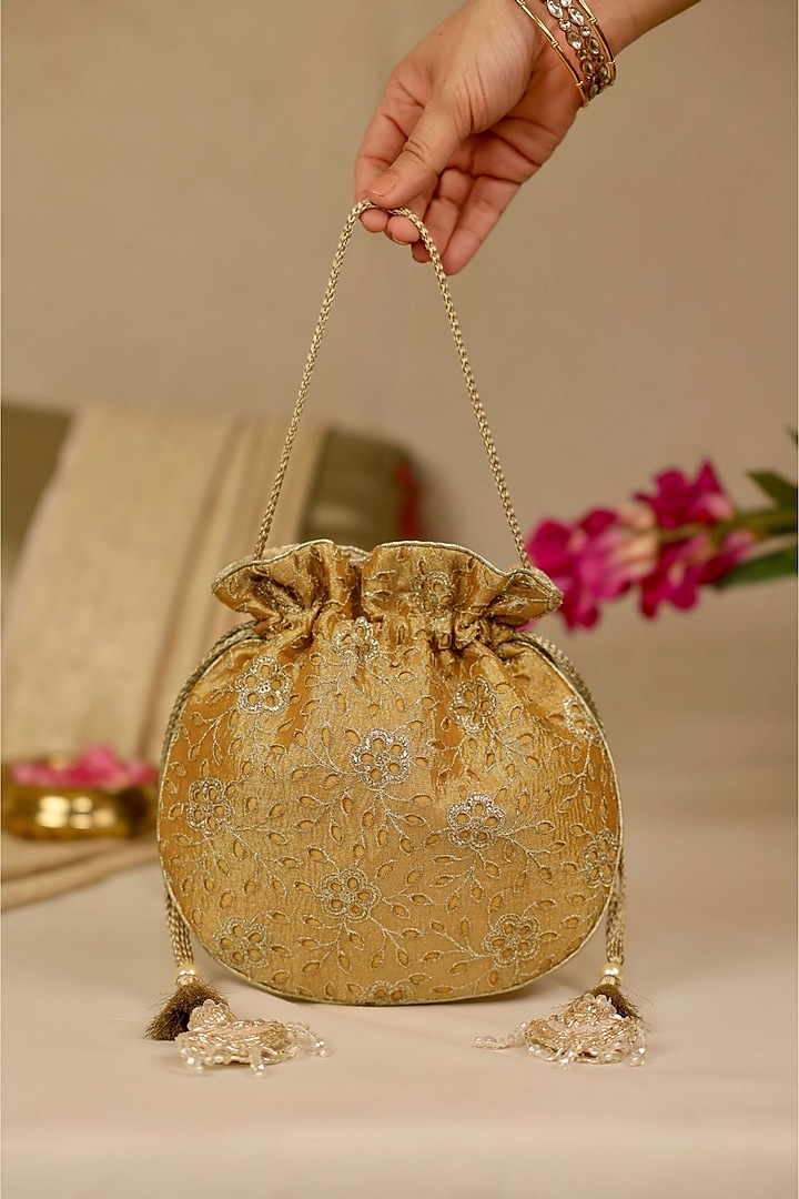 Mustard Tissue Cutwork & Zari Thread Embroidered Potli by AMYRA at Pernia's Pop Up Shop