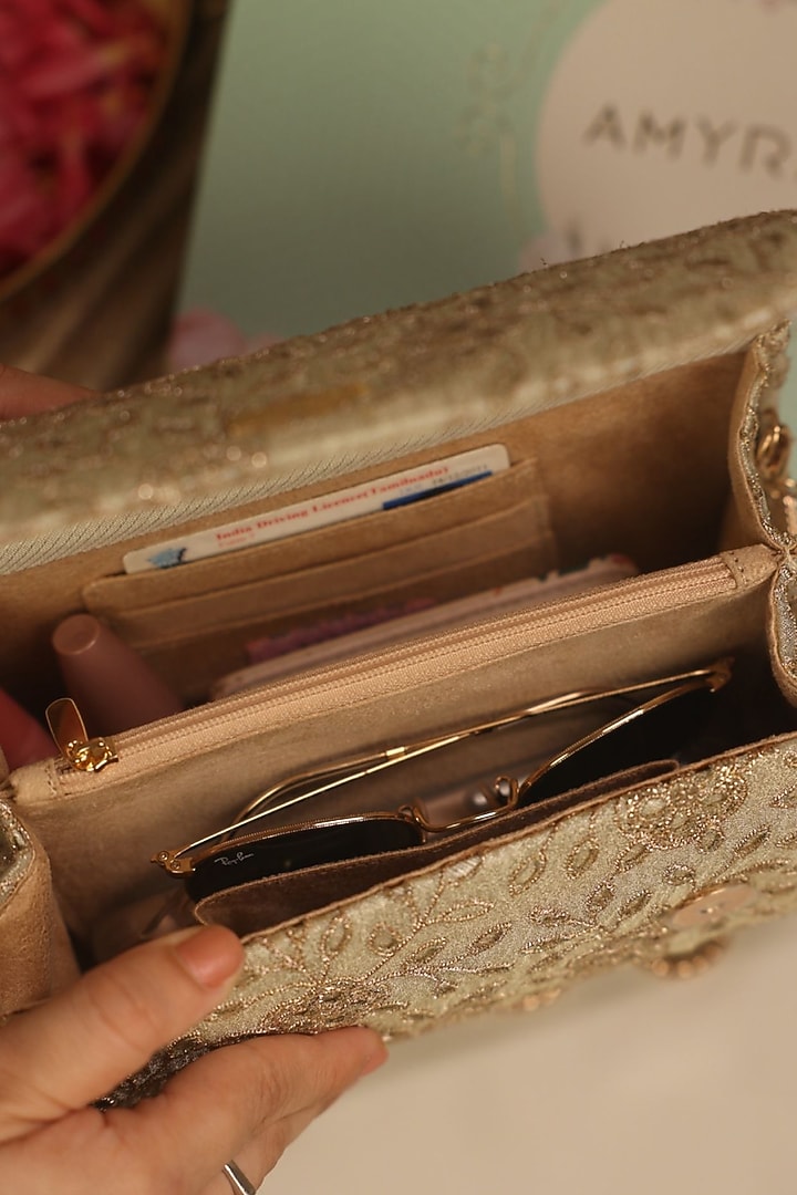 Light Gold Tissue Cutwork & Zari Thread Embroidered Flapover Bag by AMYRA at Pernia's Pop Up Shop