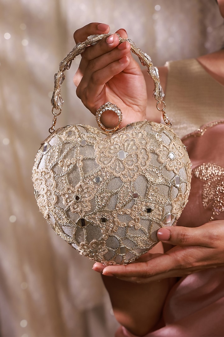 Gold Tissue Mirror Embroidered Heart Potli Bag by AMYRA at Pernia's Pop Up Shop