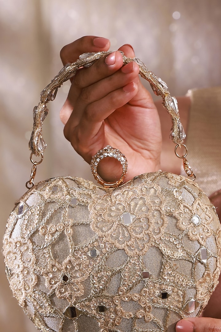Gold Tissue Mirror Embroidered Heart Potli Bag by AMYRA at Pernia's Pop Up Shop